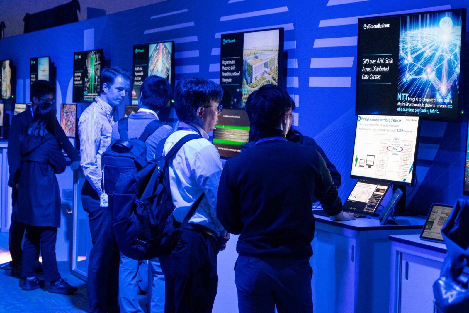 Attendees at an NTT Research demonstration booth at the Upgrade 2026 expo